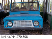 Pskov Region, Russia , July 21, 2024 - vintage blue vehicle sits stationary in a rustic shed, LUAZ. Редакционное фото, фотограф Андрей Знаменский / Фотобанк Лори