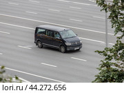 Black Volkswagen Multivan T6 riding at the city street. Редакционное фото, фотограф Константин Григорьев / Фотобанк Лори