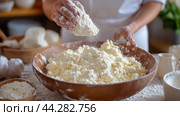 Baker sifts flour in a kitchen with fresh eggs on the counter in the morning light. Стоковое AI-изображение, AI-художник Юлия Гапеенко / Фотобанк Лори
