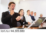 Middle aged white business man yawning at boring meeting. Стоковое фото, фотограф Яков Филимонов / Фотобанк Лори