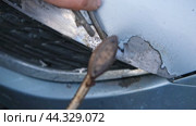 Car body shop. Repair man processes the welding seam using an angle grinder on replaced car part. Professional Body master grind old paint and rust. Rust damage. Rusting car. Hands with tool close-up. Стоковое видео, видеограф Марина Демидюк / Фотобанк Лори