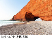 Spectacular natural red arch on atlantic ocean coast, Legzira (or Gzira) beach. Red archs on atlantic ocean coast. Sidi Ifni, Morocco, Africa (2024 год). Стоковое фото, фотограф Евгений Ткачёв / Фотобанк Лори