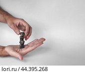 Hands rolling unique polyhedral dice in mid-air against a minimalistic background. Стоковое фото, фотограф Lamina Akulova / Фотобанк Лори
