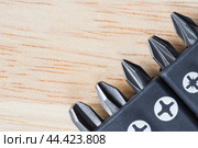 A set of tools collection from heads for screwdriver (bits) on a wooden table. Copy space. Стоковое фото, фотограф Михаил Строгалев / Фотобанк Лори