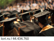 Graduation ceremony, students in caps and gowns. Стоковое AI-изображение, AI-художник Иван Рябоконь / Фотобанк Лори