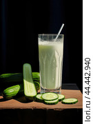 Glass of milk with fresh cucumber. Стоковое AI-изображение, AI-художник Veniamin Kraskov / Фотобанк Лори