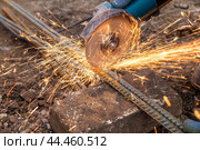 Metal cutting with a handheld machine with a cutting disc. Стоковое фото, фотограф Дмитрий Кобзев / Фотобанк Лори