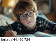 Studious young boy focused on homework. Стоковое AI-изображение, AI-художник Иван Рябоконь / Фотобанк Лори