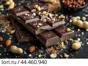 Decadent dark chocolate bar with nuts. Стоковое AI-изображение, AI-художник Иван Рябоконь / Фотобанк Лори