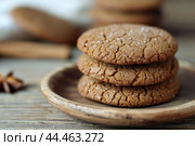 Homemade ginger snaps on rustic wooden table. Стоковое AI-изображение, AI-художник Иван Рябоконь / Фотобанк Лори