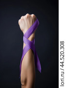 International Day for the Elimination of Violence against Women - Arm with violet ribbon. Стоковое AI-изображение, AI-художник Veniamin Kraskov / Фотобанк Лори