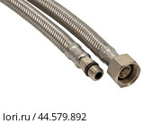 Сантехнический шланг в металлической оплетке для воды на белом фоне. Plumbing hose in a metal braid for water. Стоковое фото, фотограф Татьяна Д / Фотобанк Лори
