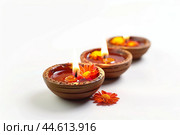 Traditional diya lamps with marigold flowers. Стоковое AI-изображение, AI-художник Иван Рябоконь / Фотобанк Лори