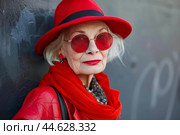 Elegant senior woman in stylish red attire. Стоковое AI-изображение, AI-художник Иван Рябоконь / Фотобанк Лори