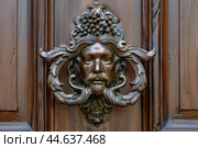 Antique bronze door knocker with bacchus design. Стоковое AI-изображение, AI-художник Иван Рябоконь / Фотобанк Лори