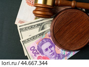 Money banknotes with judge gavel. Corruption concept with currency of Russian Rubles, Ukrainian Hryvnia and American Dollars. Стоковое фото, фотограф Сергей Толмачёв / Фотобанк Лори