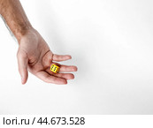 Hand holding yellow dice on white background. Стоковое фото, фотограф Lamina Akulova / Фотобанк Лори