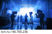 Film crew shooting movie scene on set in studio. Стоковое AI-изображение, AI-художник Юрий Поздников / Фотобанк Лори