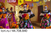 Colorful dia de los muertos celebrations with traditional catrinas in vibrant attire. Стоковое AI-изображение, AI-художник Zakharova Natasha / Фотобанк Лори