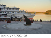 Myshkin, Yaroslavl region, Russia, 23 July, 2024: Tourist ship at pier with sundial in evening. Редакционное фото, фотограф Алексей Антипов / Фотобанк Лори