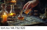 Mysterious alchemist pouring a glowing potion in a dimly lit room filled with candles and ancient magical artifacts. Стоковое AI-изображение, AI-художник Сергей Толмачёв / Фотобанк Лори