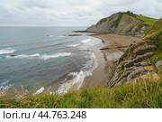 Charming Zumaia Itzurun beach. Steeply-tilted layers of flysch in Zumaia. Atlantic ocean surf in Basque Autonomous Community  in day in Bay of Biscay. View from above / top view. Стоковое фото, фотограф YuryKara / Фотобанк Лори