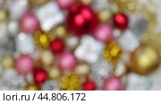 Christmas Ornaments Defocused Background Rotation. Close up a Glitter Christmas Tree Decoration Items Turning. Blurred Backdrop New Year Ornate. Many Shiny Xmas Bauble, Balls and Bulbs Bokeh. Top View. Стоковое видео, видеограф Марина Демидюк / Фотобанк Лори