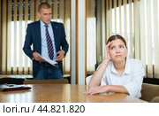 Emotional young boss berates his secretary girl in the conference room. Стоковое фото, фотограф Яков Филимонов / Фотобанк Лори