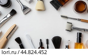 Various beauty and skincare tools arranged on a white surface, showcasing brushes, jars, and applicators in a neat layout for personal care. Стоковое AI-изображение, AI-художник Сергей Толмачёв / Фотобанк Лори