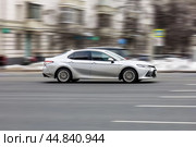 Silver car is driving on empty urban asphalt road. Редакционное фото, фотограф Константин Григорьев / Фотобанк Лори
