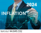 Inflation 2024. tax, cash flow and another financial concept. focused on decreasing value of money. blue background of graph of rising inflation rates 2023 2024 years. Стоковое фото, фотограф Павел Муравьев / Фотобанк Лори