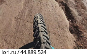 Top view of the front wheel of a mountain bike while driving on a dirt road on a sThe concept of an extreme trip. Стоковое видео, видеограф Ярославский Максим / Фотобанк Лори