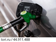 The gas station. Filling the car with gasoline. A Russian fuel dispenser in the fuel tank of a car at a gas station. Rising fuel prices around the world. Стоковое фото, фотограф Photojuli / Фотобанк Лори