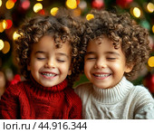Little kids make a wish on Christmas Eve. Festive New Year atmosphere. Стоковое фото, фотограф Сергей Елизарьев / Фотобанк Лори