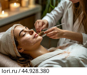 The beautician applies a cleansing clay mask to the girl's face while she lies in the chair. It gently exfoliates dead cells, smoothes the texture and evens out the tone. Стоковое AI-изображение, AI-художник Сергей Елизарьев / Фотобанк Лори