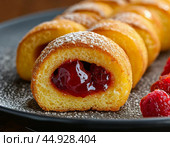 Sponge cake roll made of yeast dough with jam inside. Still life. Стоковое AI-изображение, AI-художник Сергей Елизарьев / Фотобанк Лори