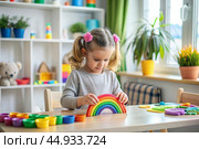 Toys. A little girl is playing educational games. A rainbow-shaped children's toy, colored pyramids and logic toys for children. Montessori games for child development. Стоковое AI-изображение, AI-художник Photojuli / Фотобанк Лори