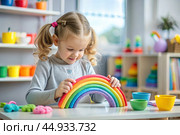 Toys. A little girl is playing educational games. A rainbow-shaped children's toy, colored pyramids and logic toys for children. Montessori games for child development. Стоковое AI-изображение, AI-художник Photojuli / Фотобанк Лори