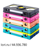 Stack of colorful vhs video cassette tapes isolated on white background. Стоковое AI-изображение, AI-художник Иван Рябоконь / Фотобанк Лори