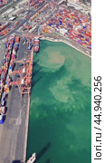 Cranes maneuvering shipping containers at a busy port efficiently load and unload cargo from large vessels, showcasing the dynamic nature of maritime logistics. Стоковое видео, видеограф ILIA GOROKHOV / Фотобанк Лори