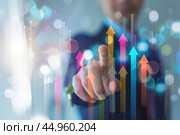Increased profits. Benchmarking. Businessman analyzes profitability of working companies with digital augmented reality graphics, positive indicators, growing up graph and charts, colorful arrows. Стоковое AI-изображение, AI-художник Марина Демидюк / Фотобанк Лори