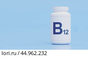 Vitamin B12 Supplement Bottle Blue Background, Essential Nutrient Health,B12 Dietary Support, Wellness Product, Medical Prevention, Energy Boosting Pills. Стоковое фото, фотограф Павел Муравьев / Фотобанк Лори