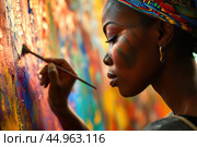 A woman artist creating a vibrant mural that pays homage to African culture and history. Стоковое AI-изображение, AI-художник Veniamin Kraskov / Фотобанк Лори