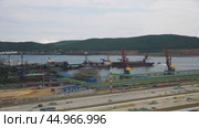 Port Activity Featuring Cranes and Various Vessels Operating Throughout the Harbor. Стоковое видео, видеограф Victor Kaprov / Фотобанк Лори