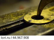Close up of metal worker using divider calipers on metal plate. Стоковое AI-изображение, AI-художник Иван Рябоконь / Фотобанк Лори