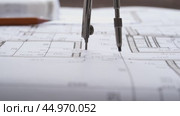 The designer draws with a compass and ruler on the drawing. Стоковое видео, видеограф Igor Skripachev / Фотобанк Лори