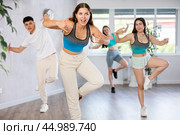 Young girl practicing hip-hop movements during group dance class. Стоковое фото, фотограф Яков Филимонов / Фотобанк Лори