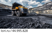 Large construction vehicle working in an expansive coal mine under a cloudy sky during daylight hours. Стоковое AI-изображение, AI-художник Сергей Толмачёв / Фотобанк Лори