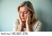 Woman suffering from severe headache or migraine, holding her head in discomfort. Stress, anxiety, and frustration visible. physical and emotional pain. Health issues like tension. Стоковое AI-изображение, AI-художник Павел Муравьев / Фотобанк Лори