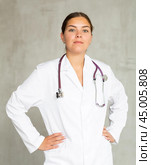 Young focused female doctor standing with pride. Стоковое фото, фотограф Яков Филимонов / Фотобанк Лори